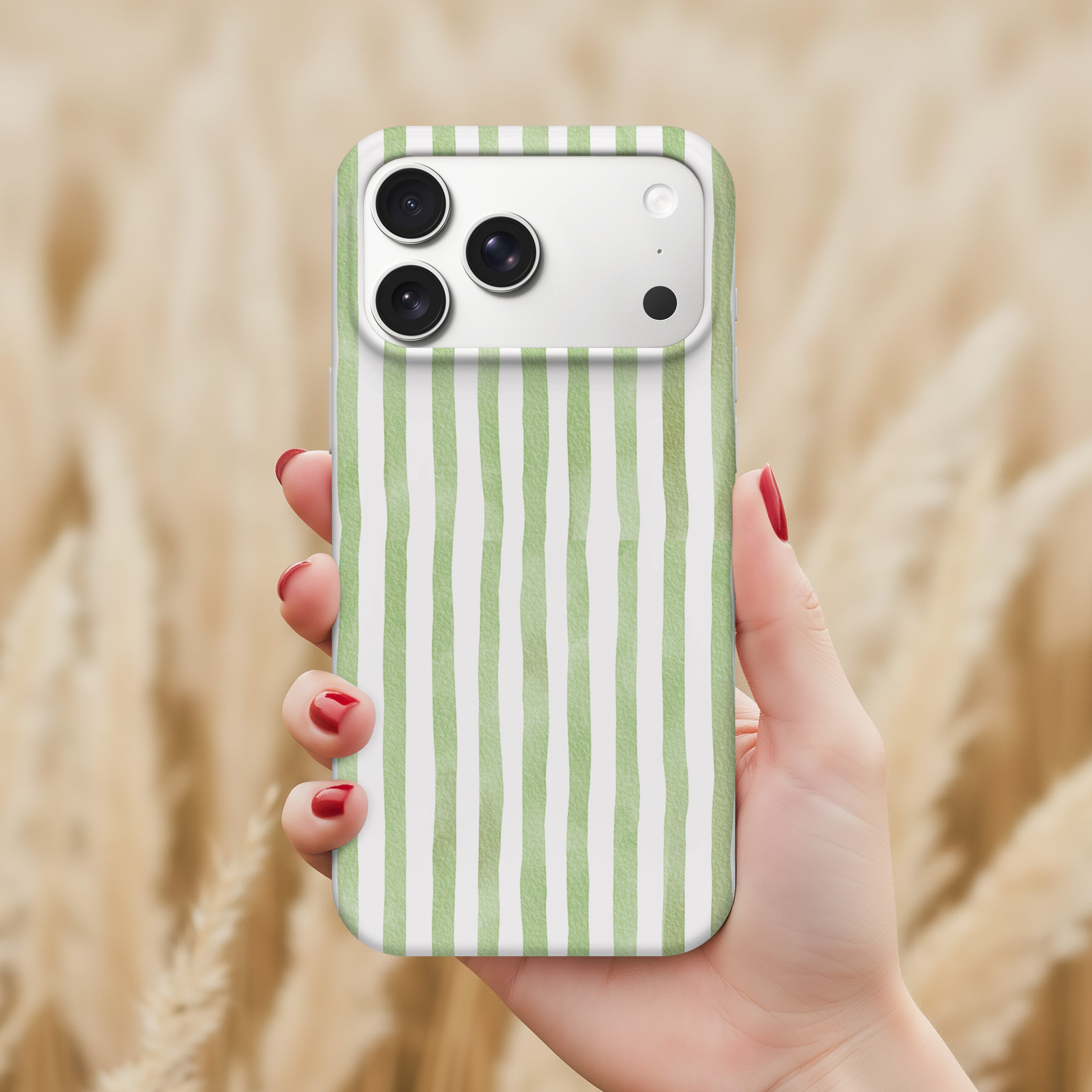 A hand holding a phone with a green and white striped pattern on the back cover.