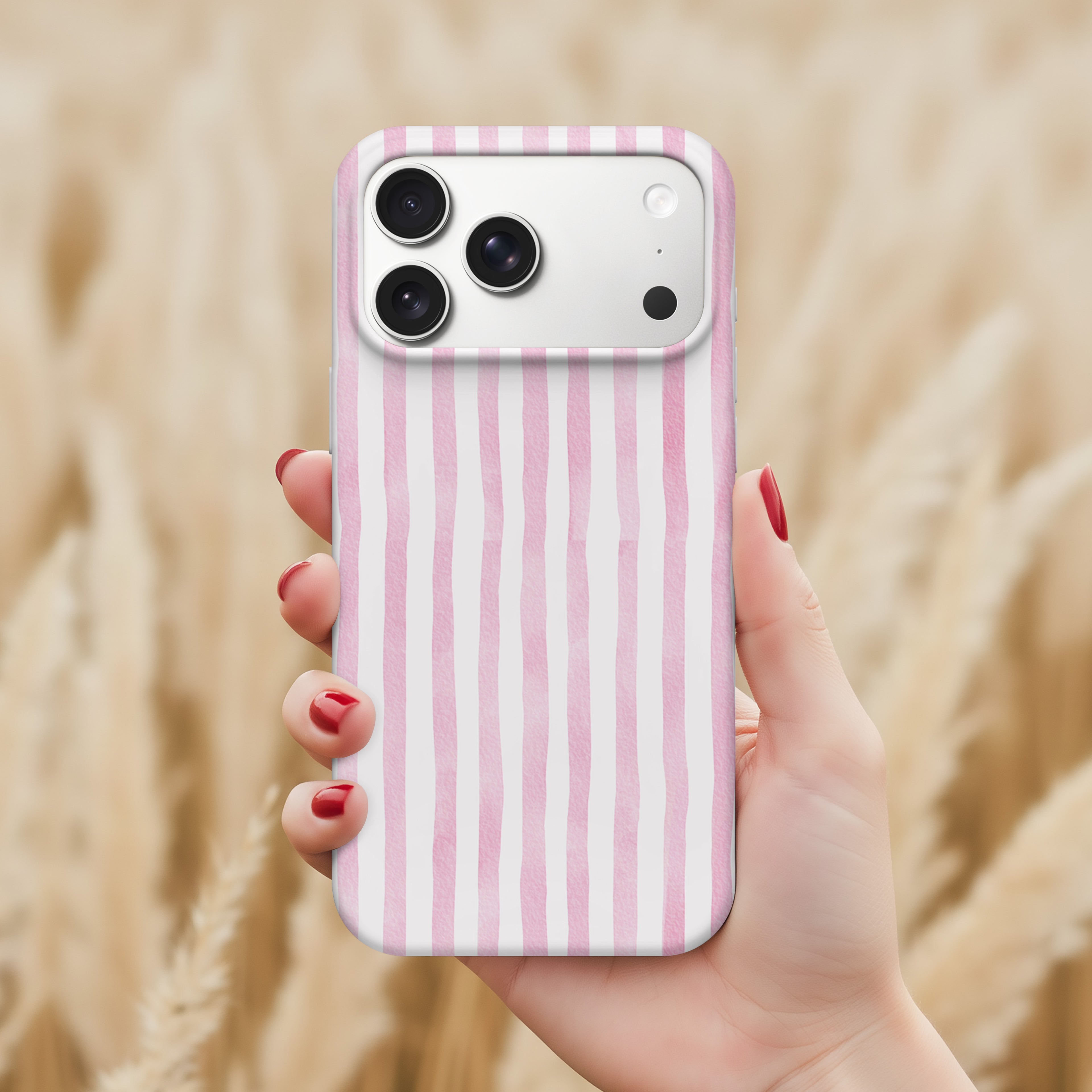 A hand holding a pink and white striped phone case with a camera on the back.