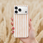 A hand holding a smartphone with a striped pattern on the back cover.